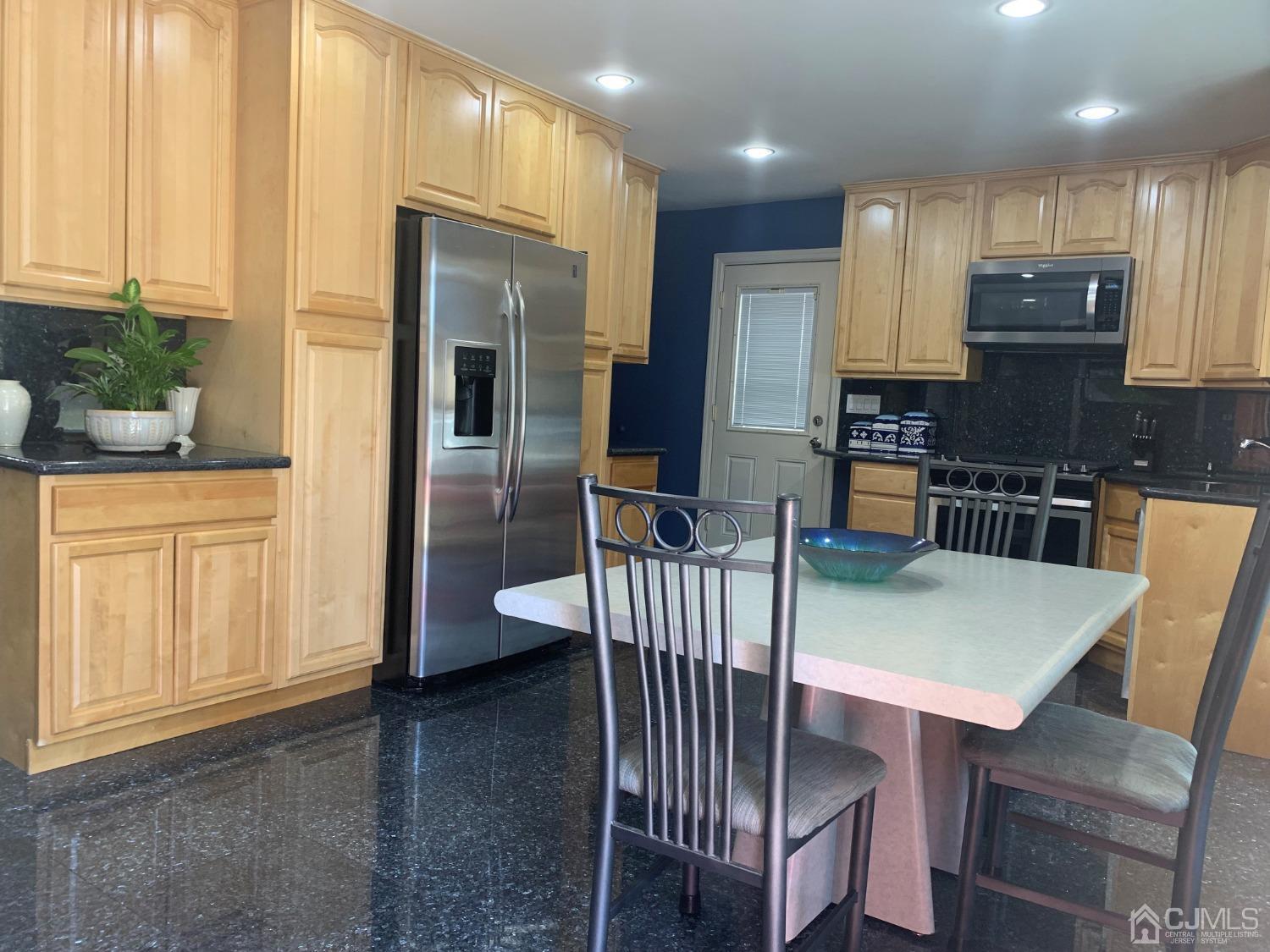 19 Columbia Road Old Bridge, NJ 08859 - Photo 4 of 24 a kitchen with a table chairs refrigerator and cabinets