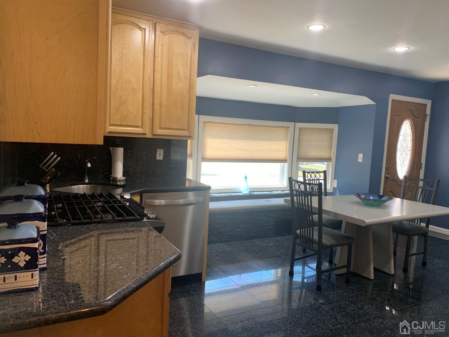19 Columbia Road Old Bridge, NJ 08859 - Photo 8 of 24 a kitchen with granite countertop a sink a stove and a refrigerator