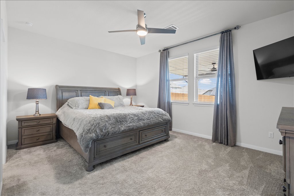 158 Gullivers Drive Elgin, TX 78621 - Photo 16 of 36 The primary bedroom is completely tucked away from the main hustle and bustle of the house.