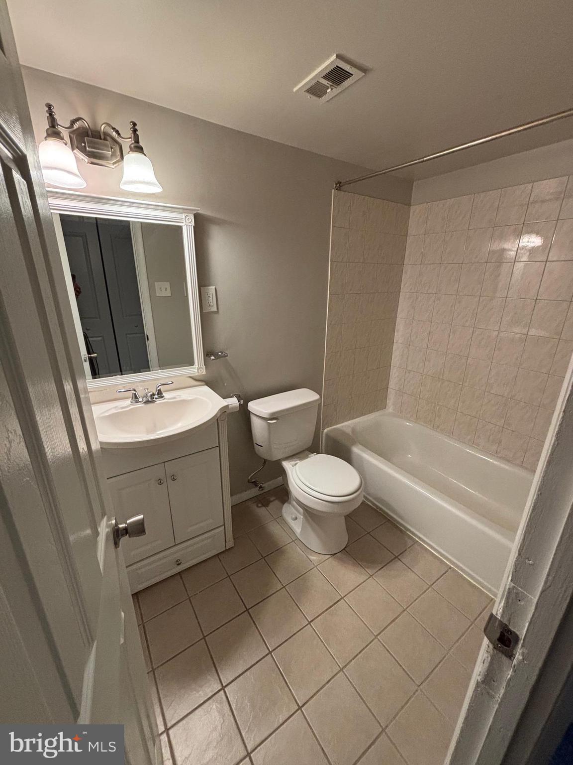3853 St Barnabas Road, Unit 202 Suitland, MD 20746 - Photo 19 of 20 a bathroom with a toilet sink and mirror