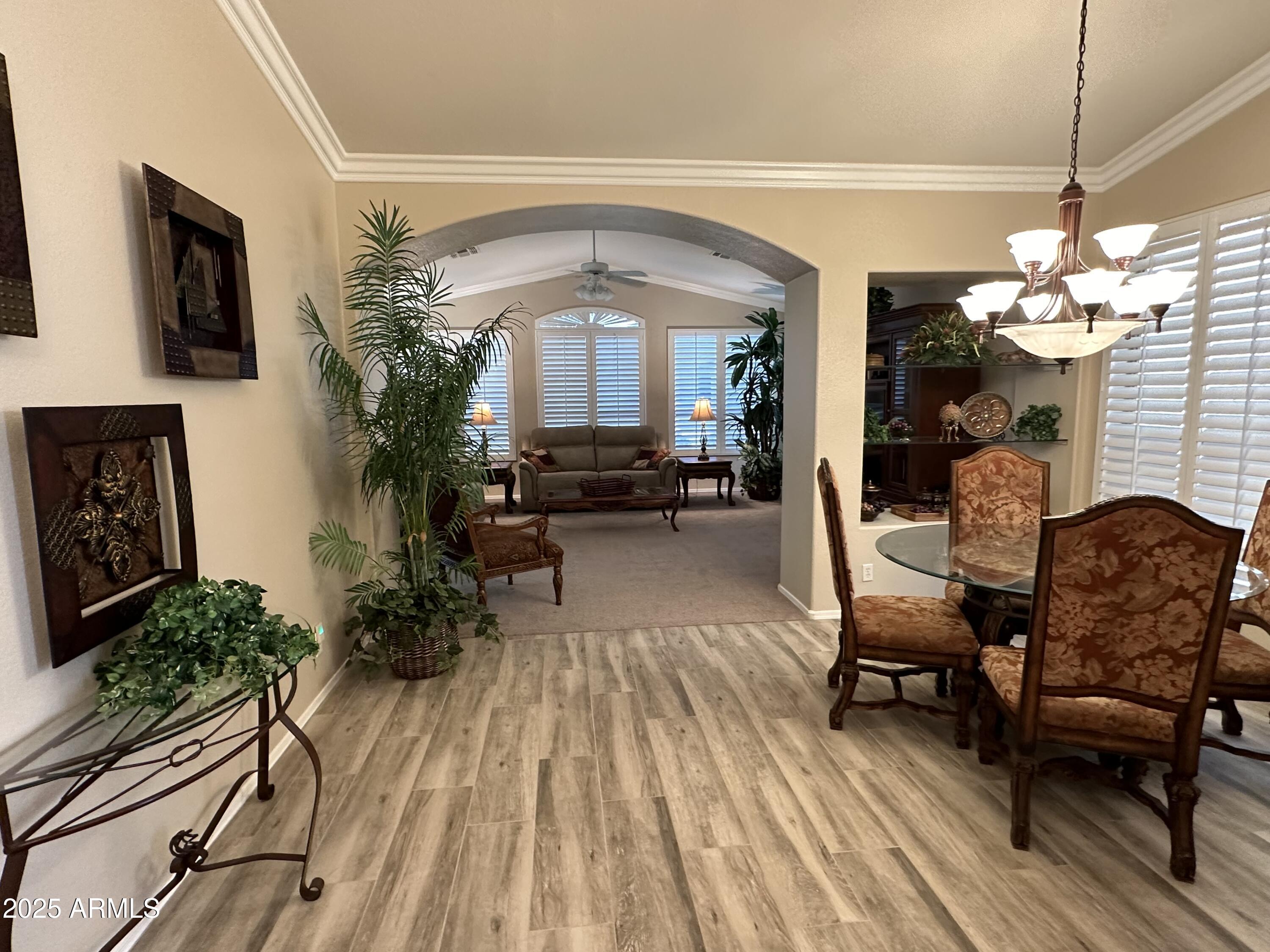 9757 East Tranquility Way Sun Lakes, AZ 85248 - Photo 2 of 10 a living room with furniture and a chandelier