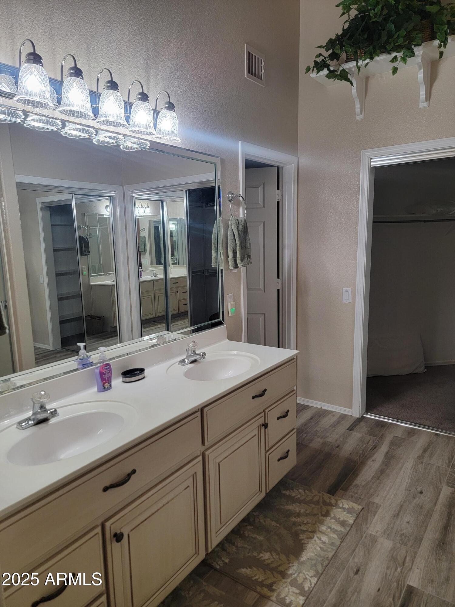9757 East Tranquility Way Sun Lakes, AZ 85248 - Photo 7 of 10 a bathroom with a double vanity sink and a mirror