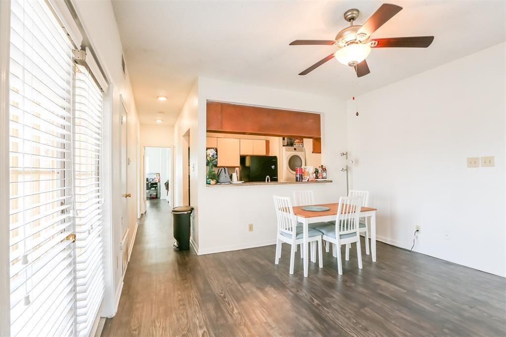 a dining room with furniture window and wooden floor