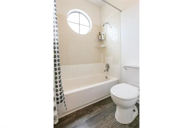 a bathroom with a toilet and a bathtub