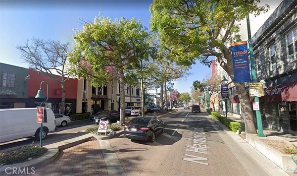 a view of a street with cars on the road