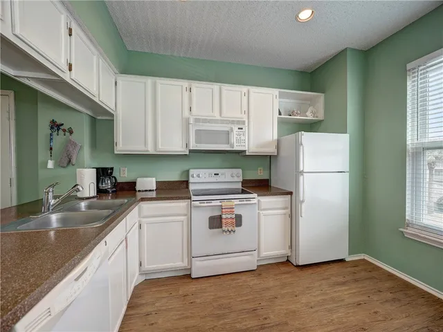 a kitchen with a white cabinets and white appliances