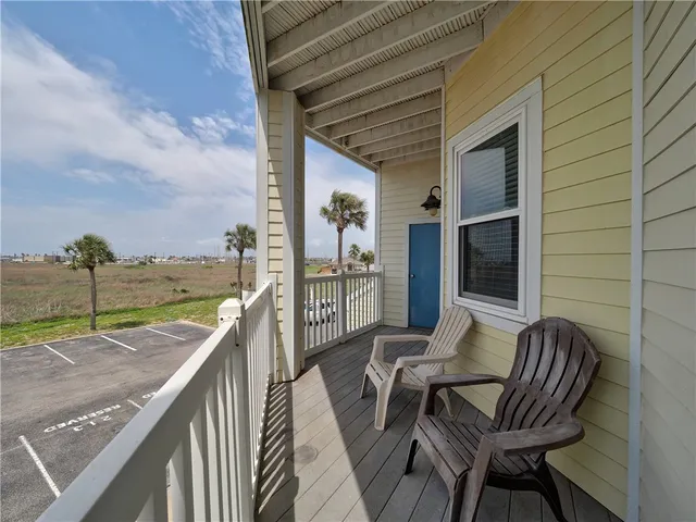 a balcony with table and chairs