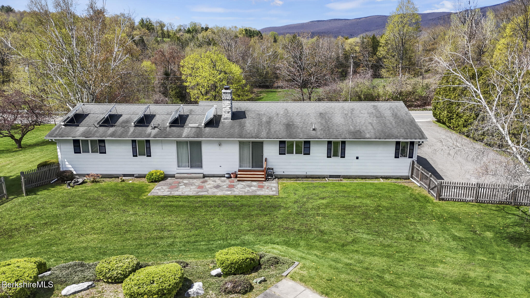 75 East Road Adams, MA 01220 - Photo 39 of 42 a aerial view of a house with table and chairs under an umbrella