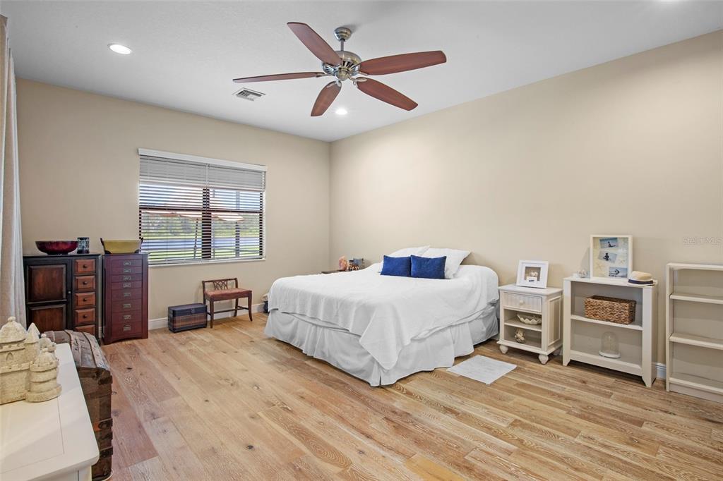 3511 Twin Rivers Trail Parrish, FL 34219 - Photo 16 of 43 a bedroom with a bed and a large window