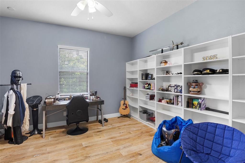 3511 Twin Rivers Trail Parrish, FL 34219 - Photo 26 of 43 a livingroom with fridge and workspace