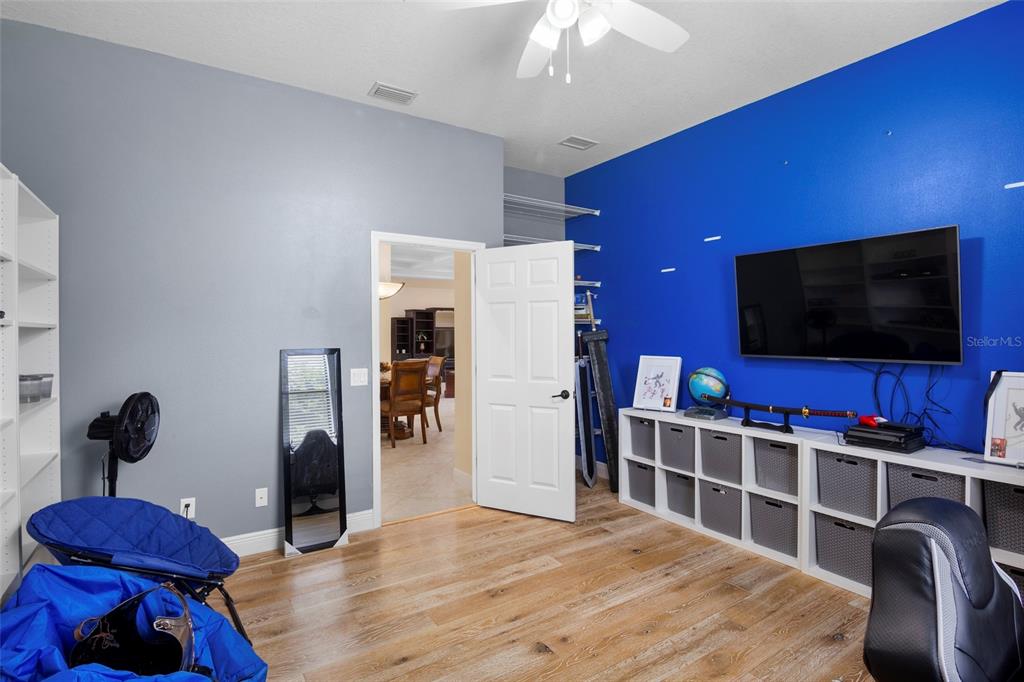 3511 Twin Rivers Trail Parrish, FL 34219 - Photo 27 of 43 a bedroom with furniture and a flat screen tv