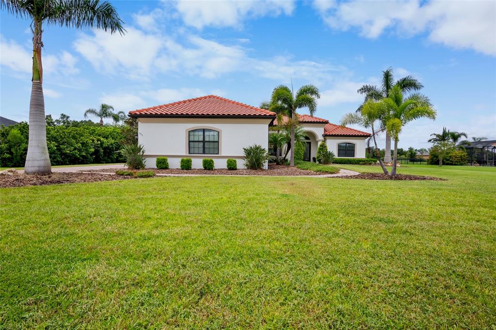 3511 Twin Rivers Trail Parrish, FL 34219 - Photo 3 of 43 a front view of a house with a garden and trees
