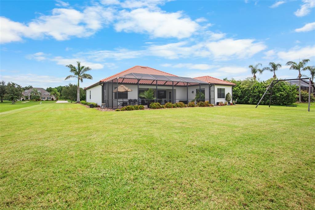 3511 Twin Rivers Trail Parrish, FL 34219 - Photo 42 of 43 a view of a house next to a big yard with large trees