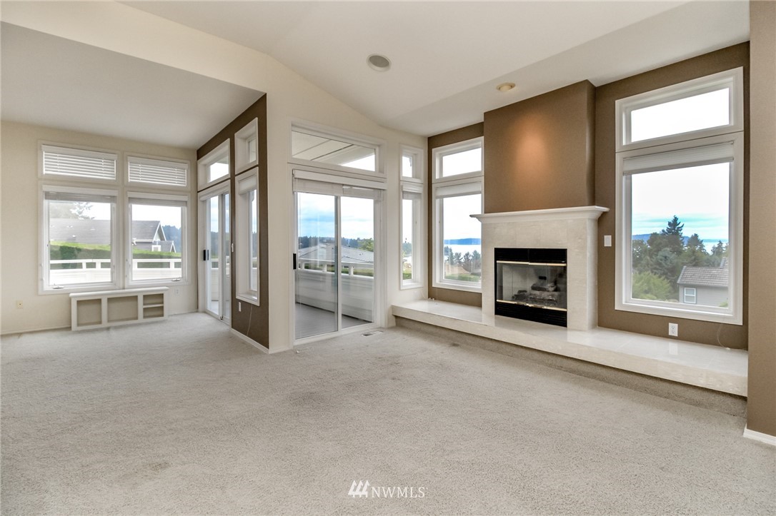 152 Cormorant Drive Steilacoom, WA 98388 - Photo 15 of 40 a view of an empty room with windows and a fireplace