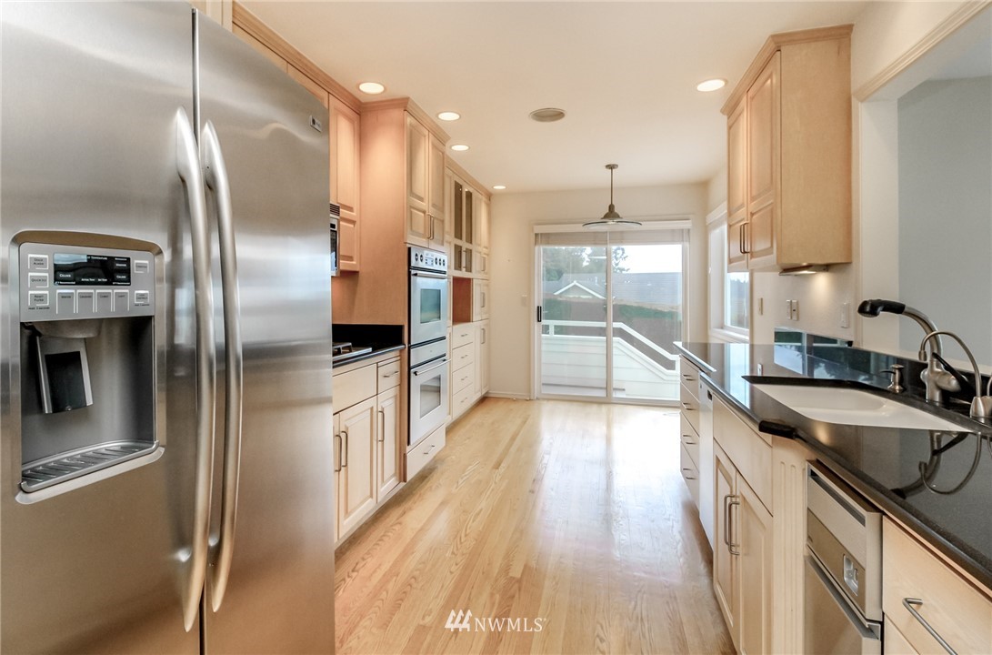 152 Cormorant Drive Steilacoom, WA 98388 - Photo 19 of 40 a kitchen with stainless steel appliances granite countertop a refrigerator a sink and a stove