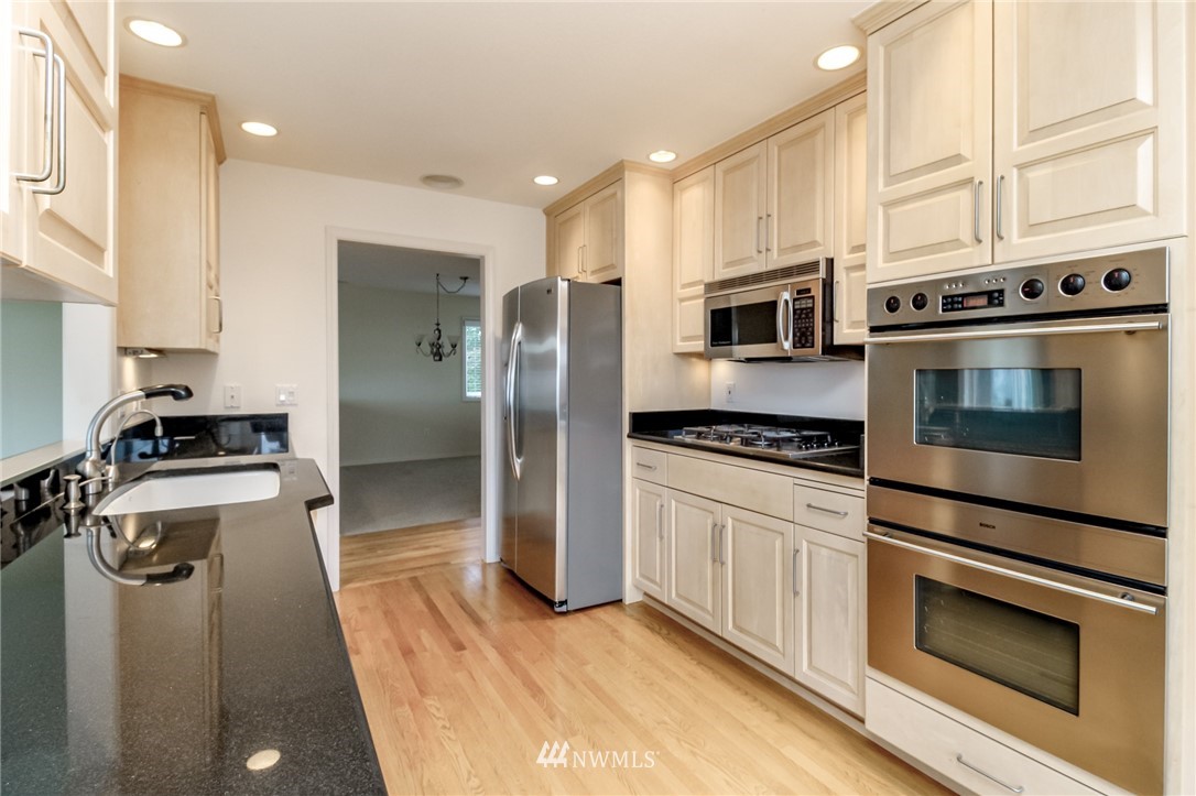 152 Cormorant Drive Steilacoom, WA 98388 - Photo 20 of 40 a kitchen with stainless steel appliances a stove a microwave and a refrigerator