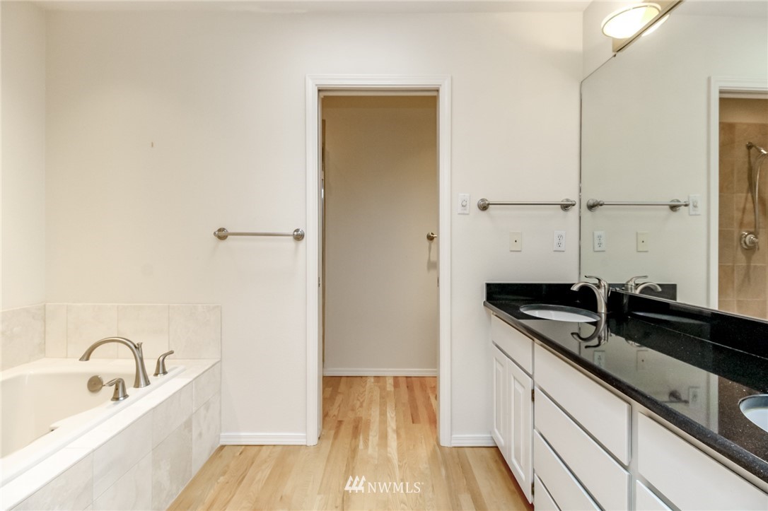 152 Cormorant Drive Steilacoom, WA 98388 - Photo 29 of 40 a bathroom with a granite countertop sink and a tub