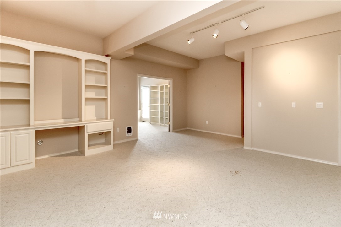 152 Cormorant Drive Steilacoom, WA 98388 - Photo 33 of 40 an empty room with a fireplace and cabinet