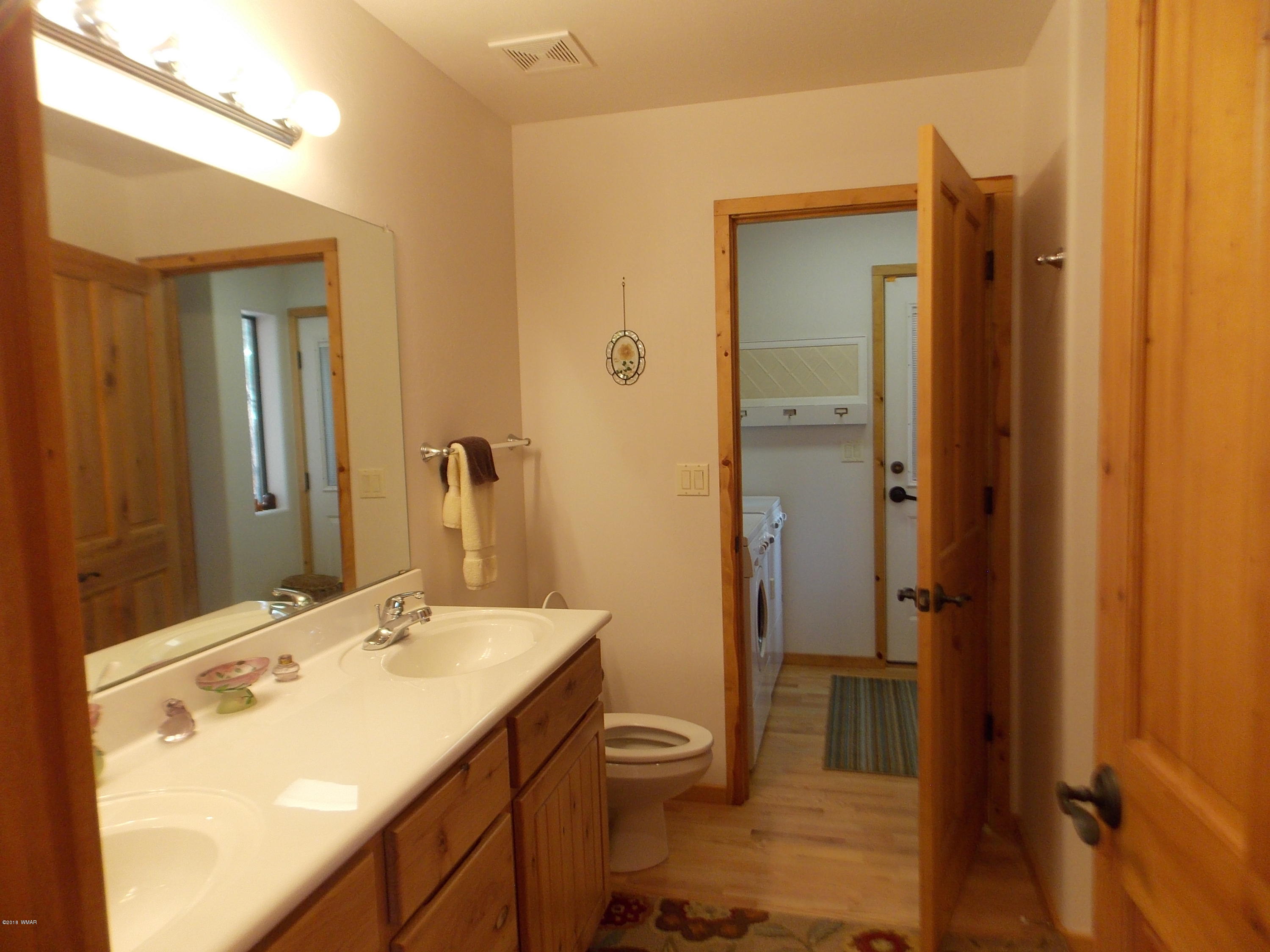 2296 Sunrise Road Overgaard, AZ 85933 - Photo 13 of 66 a bathroom with a granite countertop sink toilet and shower
