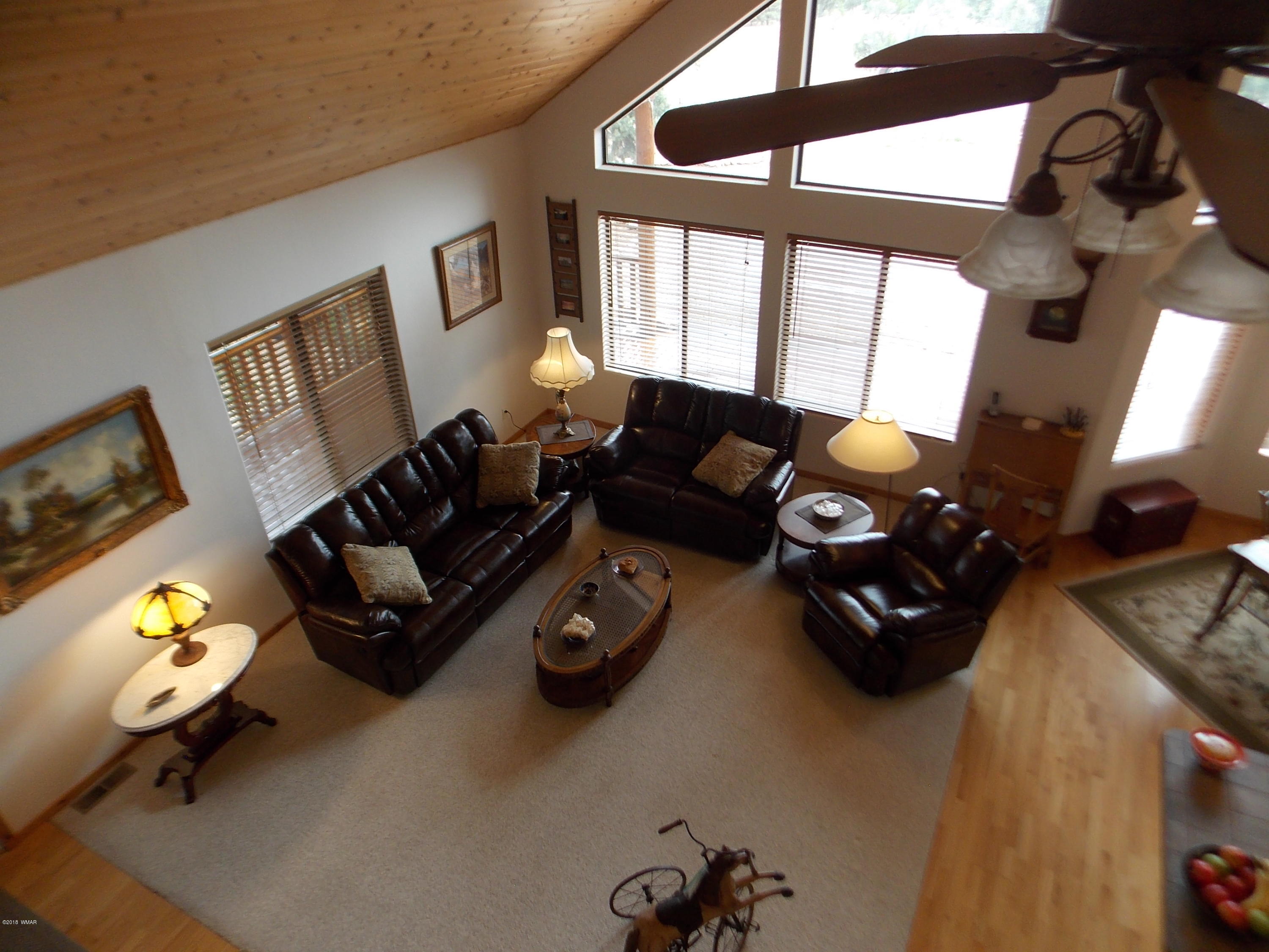 2296 Sunrise Road Overgaard, AZ 85933 - Photo 18 of 66 a living room with furniture and a flat screen tv