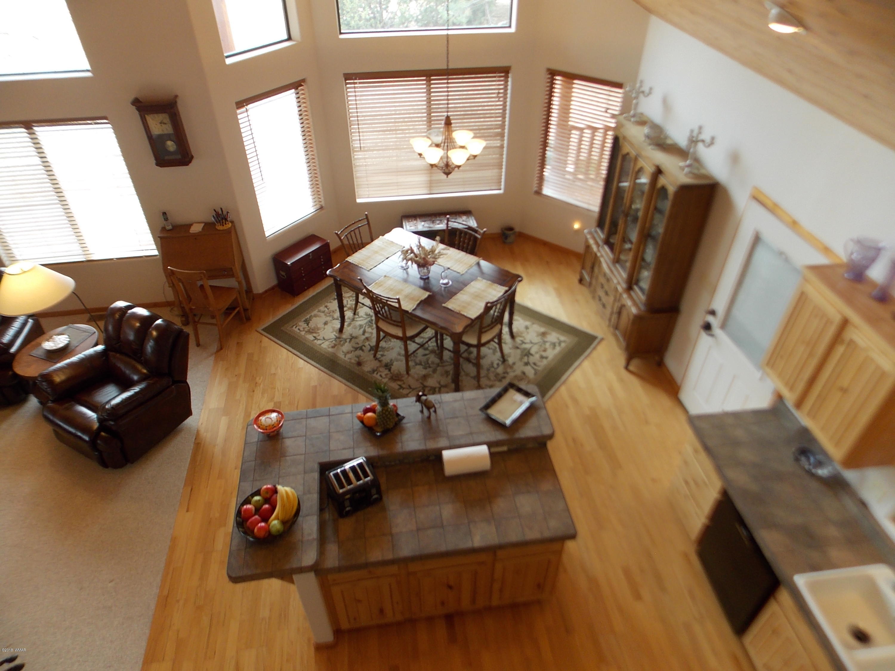 2296 Sunrise Road Overgaard, AZ 85933 - Photo 19 of 66 a view of a living room with furniture and a flat screen tv