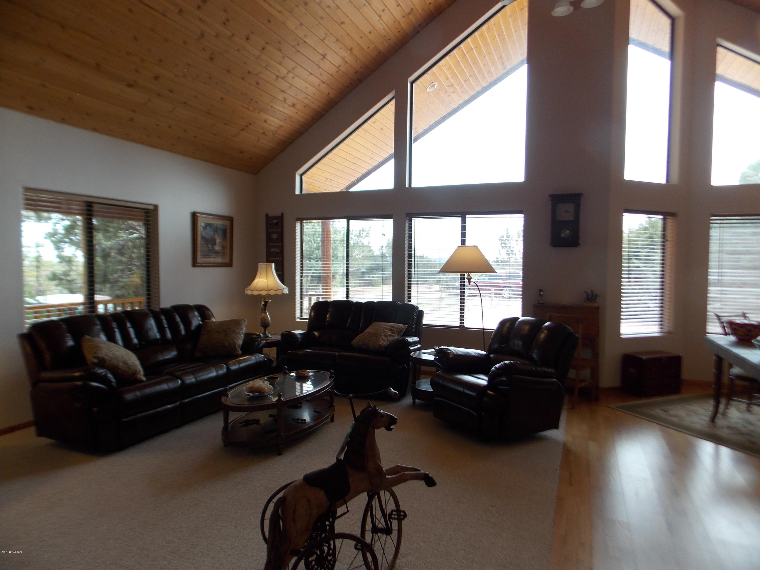 2296 Sunrise Road Overgaard, AZ 85933 - Photo 2 of 66 a living room with furniture and a large window