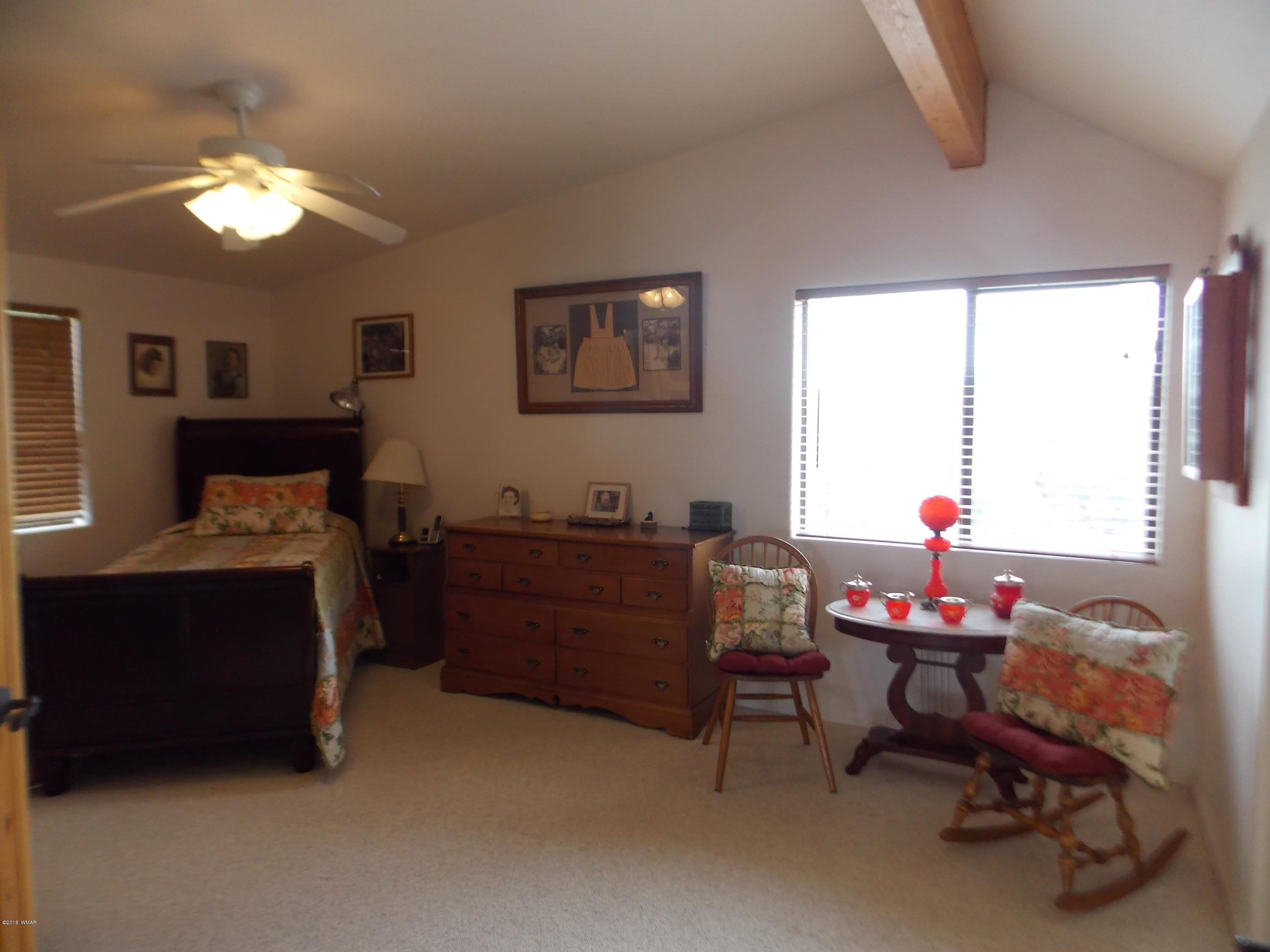 2296 Sunrise Road Overgaard, AZ 85933 - Photo 22 of 66 a bed room with furniture and a window