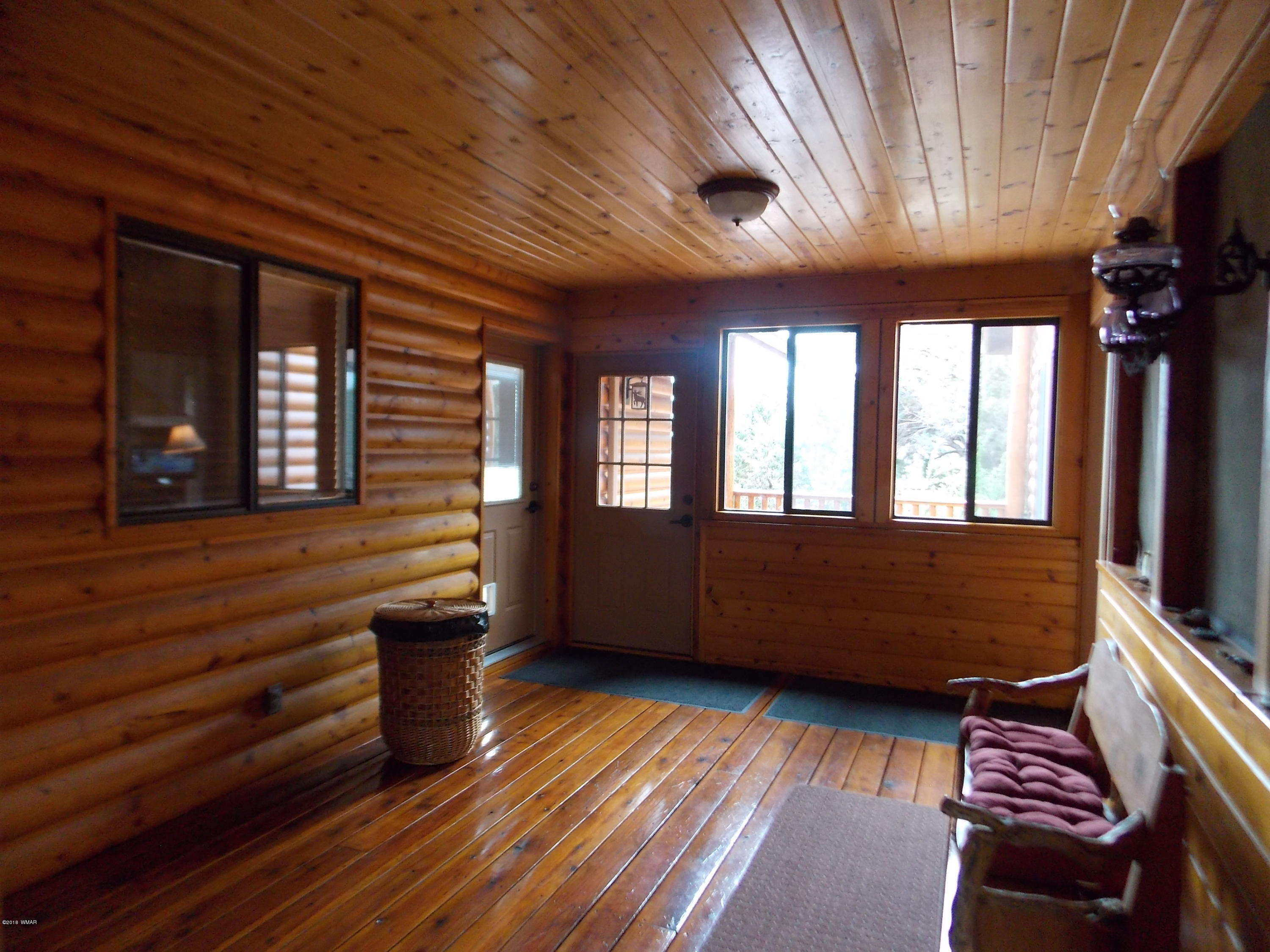 2296 Sunrise Road Overgaard, AZ 85933 - Photo 28 of 66 a view of an outdoor space with wooden floor and a window