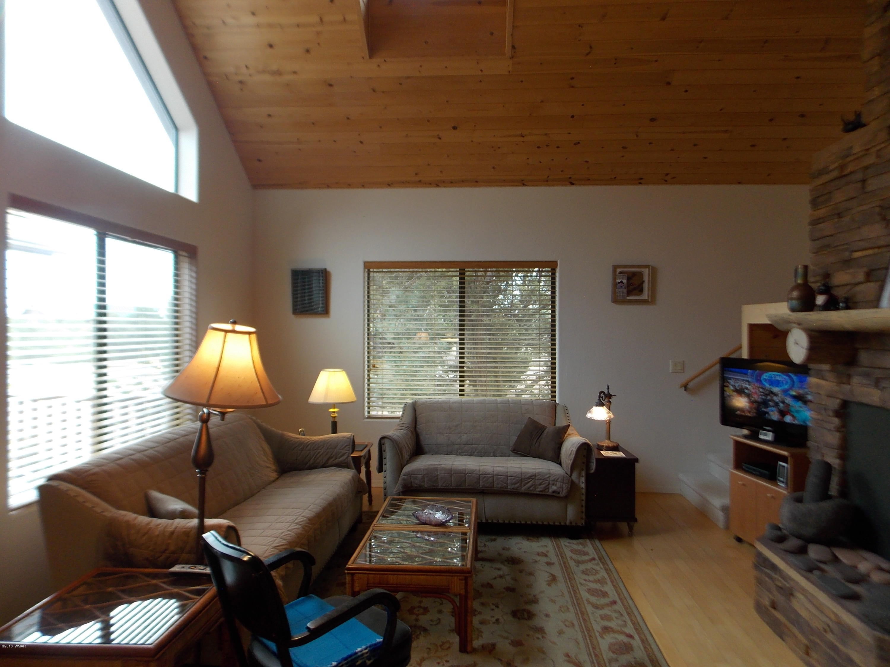 2296 Sunrise Road Overgaard, AZ 85933 - Photo 29 of 66 a living room with furniture and a lamp
