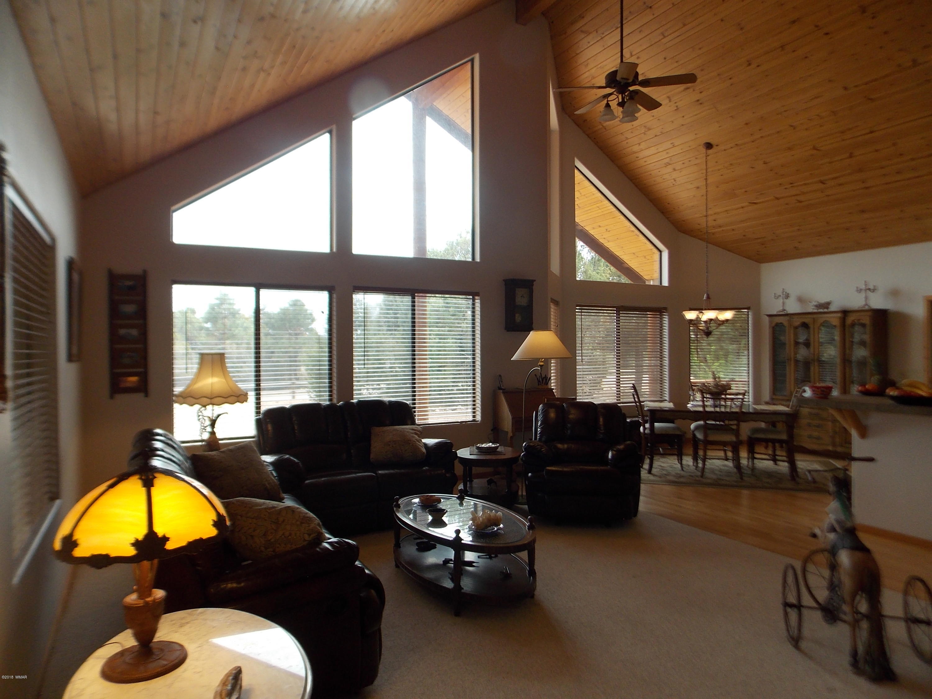 2296 Sunrise Road Overgaard, AZ 85933 - Photo 3 of 66 a living room with furniture and a large window