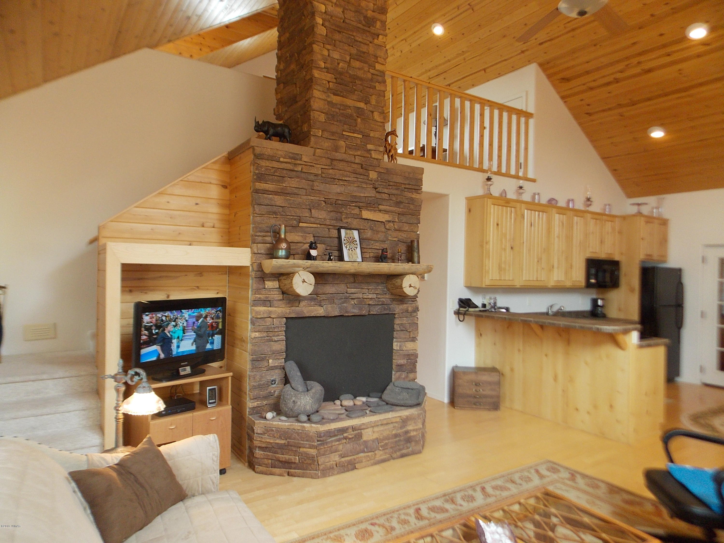 2296 Sunrise Road Overgaard, AZ 85933 - Photo 31 of 66 a living room with furniture and a fireplace