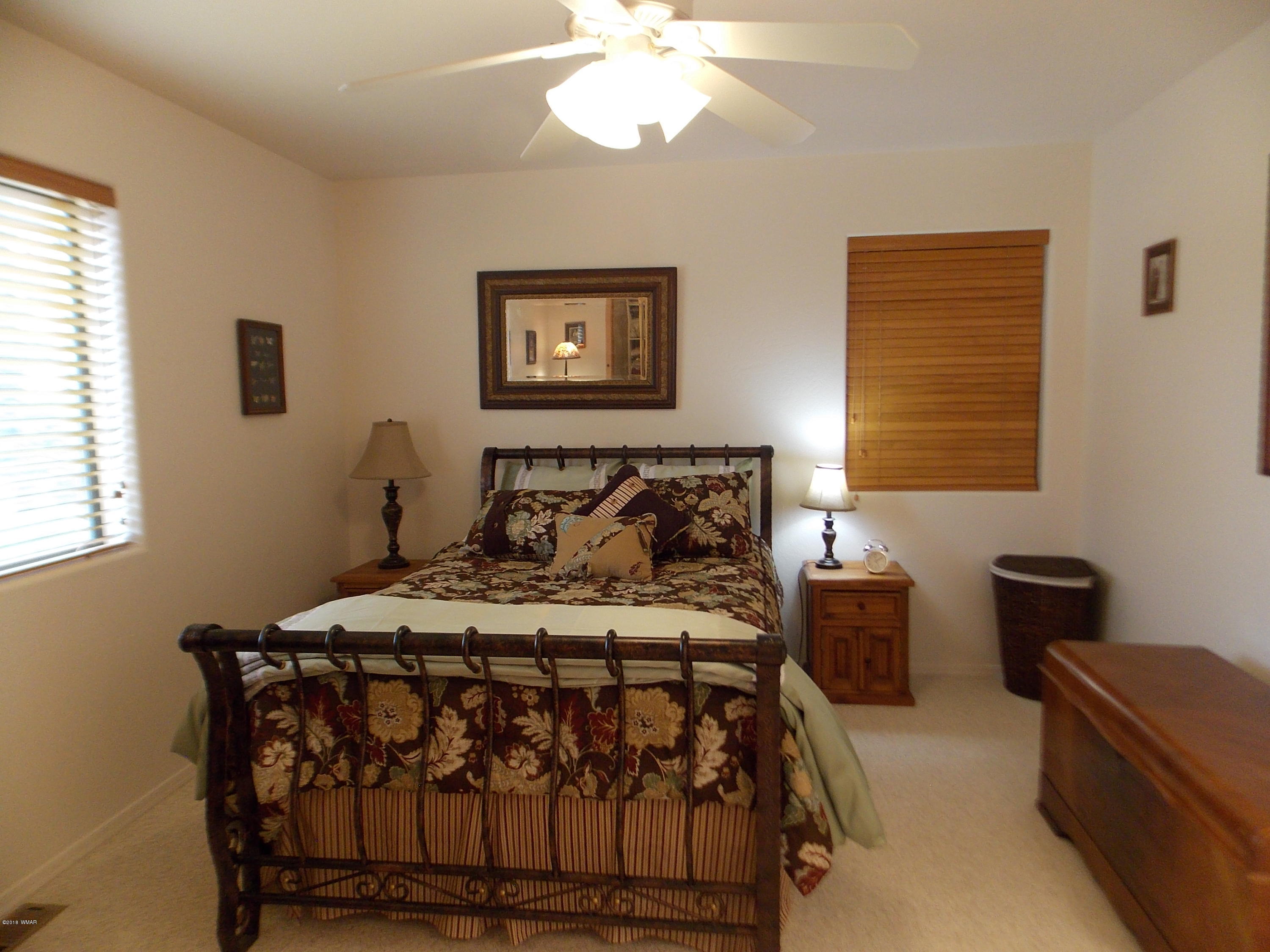 2296 Sunrise Road Overgaard, AZ 85933 - Photo 36 of 66 a bedroom with a bed and a window