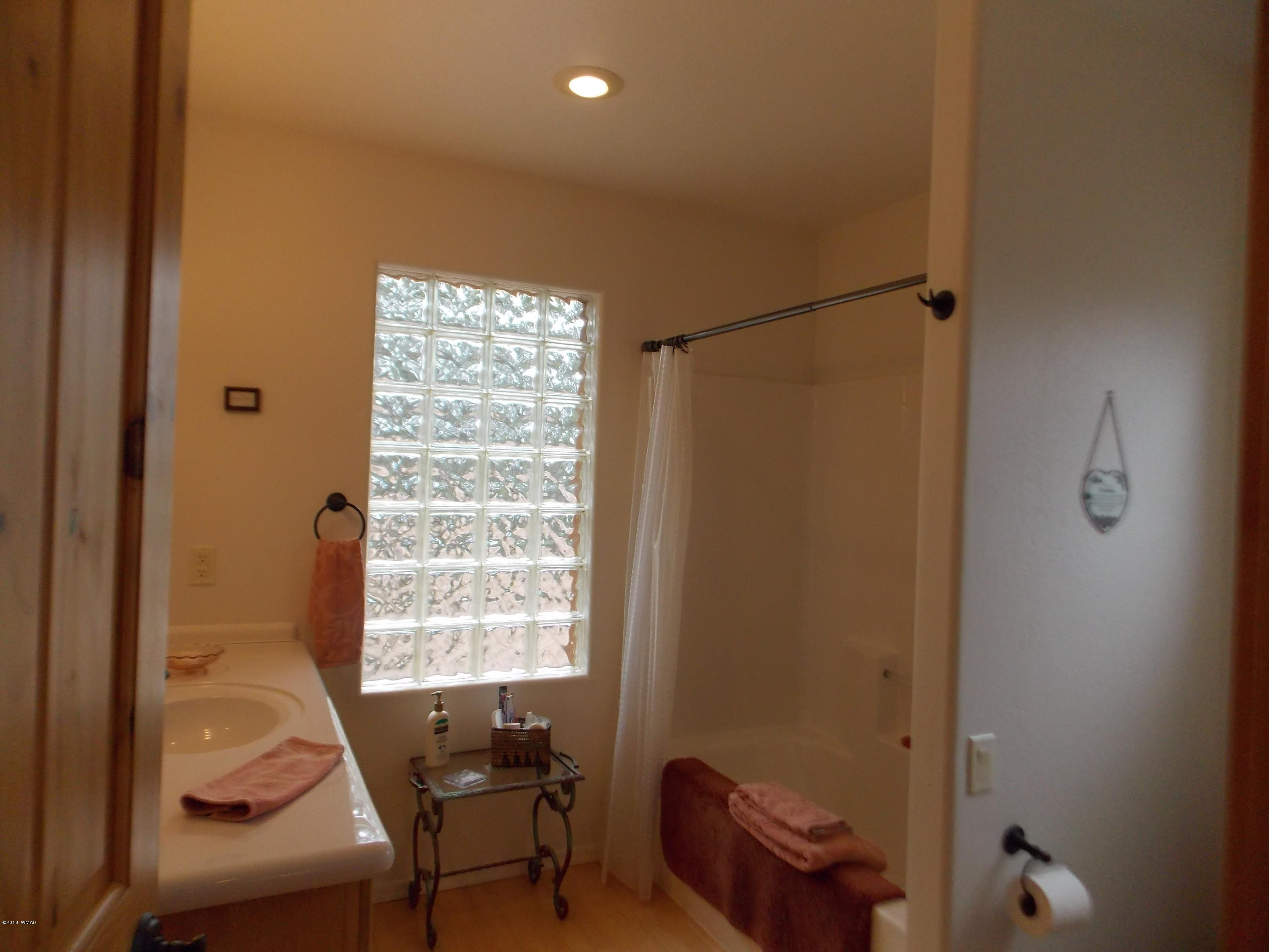 2296 Sunrise Road Overgaard, AZ 85933 - Photo 39 of 66 a bedroom with a bed and a window