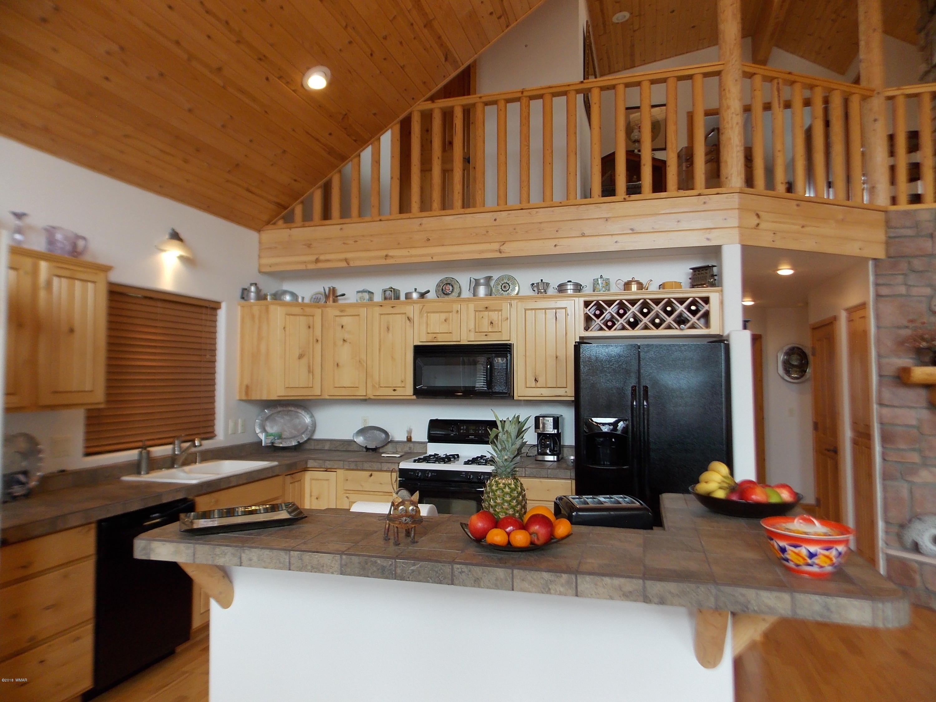 2296 Sunrise Road Overgaard, AZ 85933 - Photo 5 of 66 a kitchen with a sink appliances and cabinets