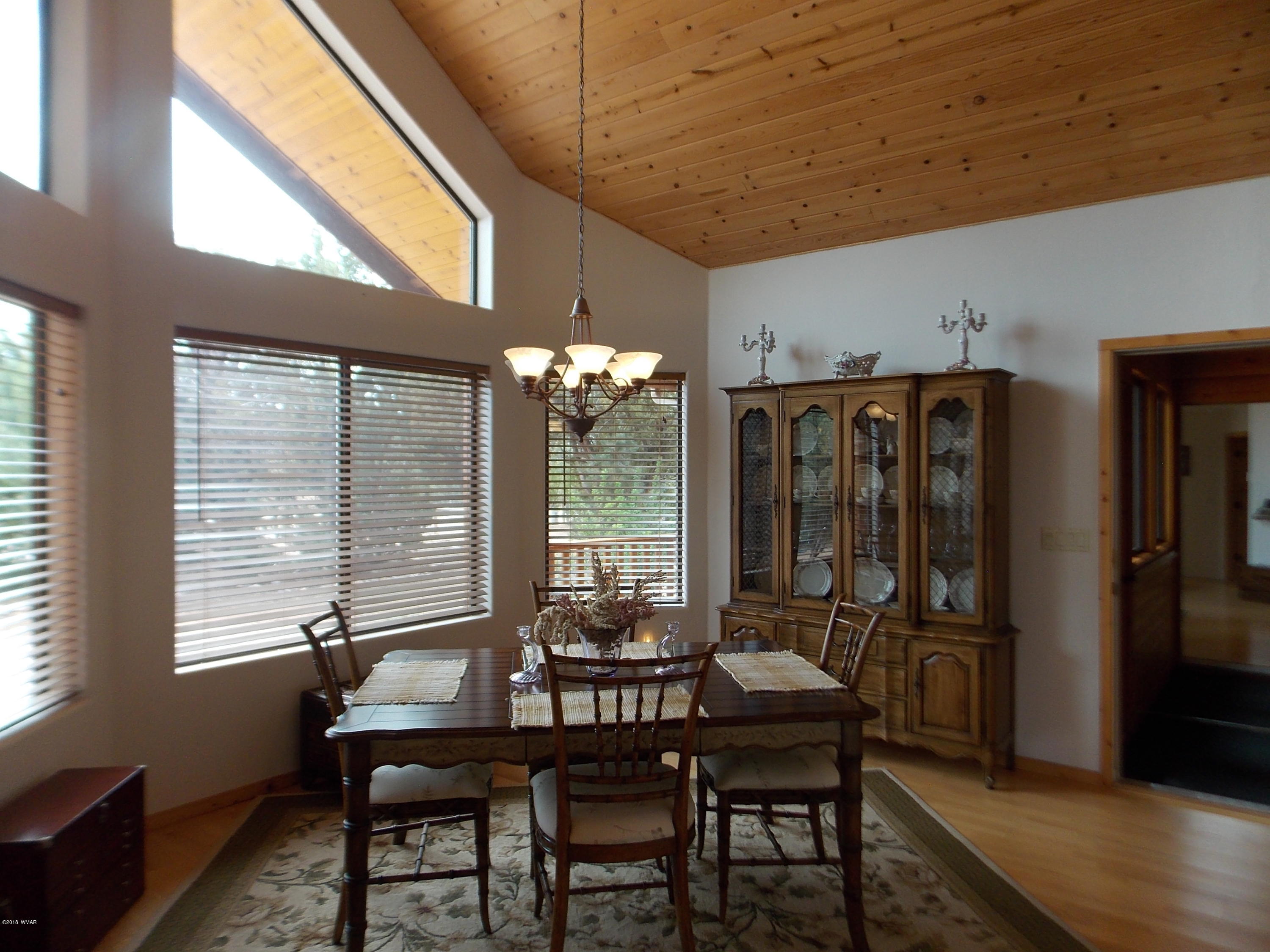 2296 Sunrise Road Overgaard, AZ 85933 - Photo 7 of 66 a view of a dining room with furniture window and outside view