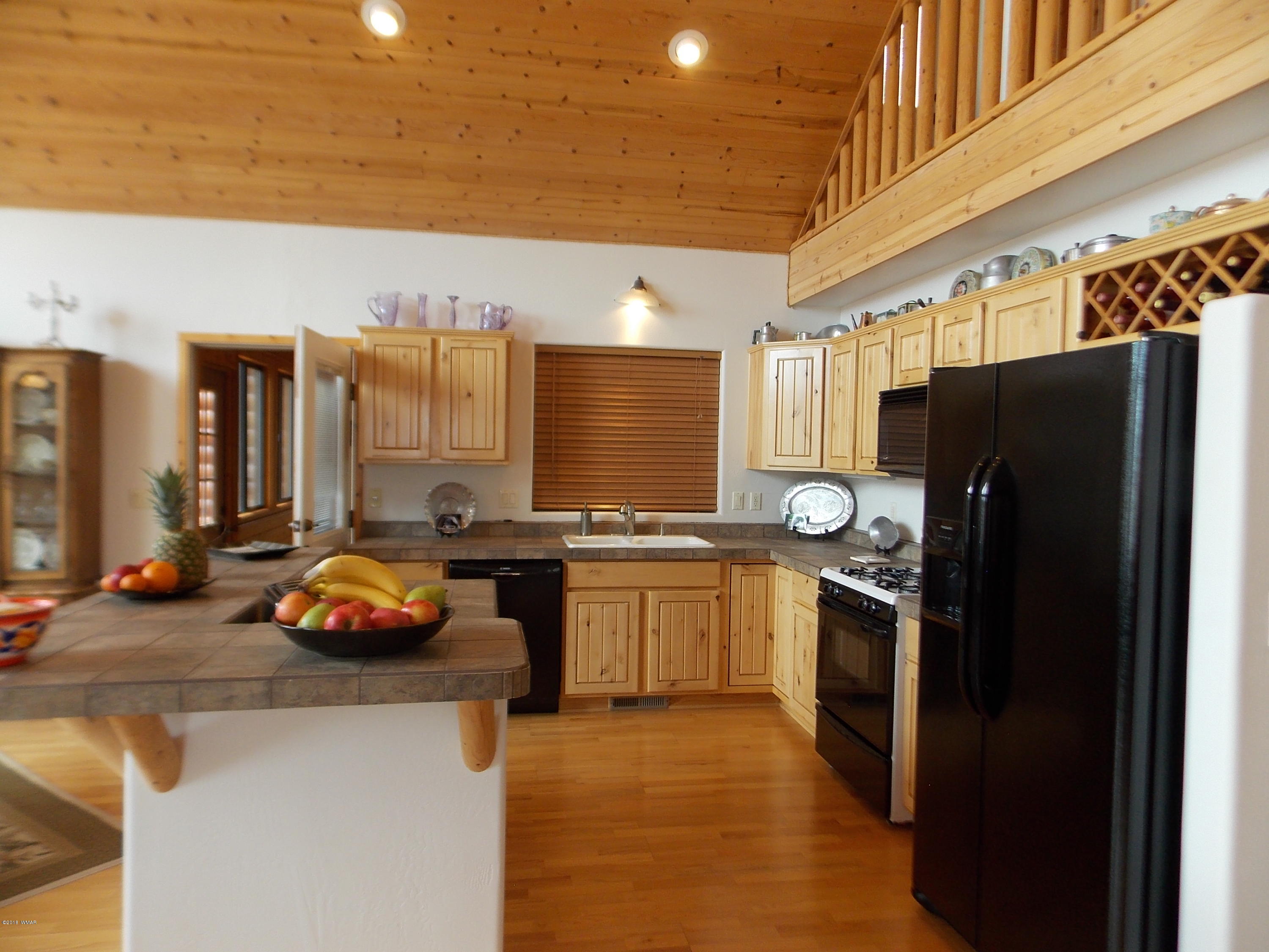 2296 Sunrise Road Overgaard, AZ 85933 - Photo 9 of 66 a kitchen with stainless steel appliances a refrigerator sink and stove