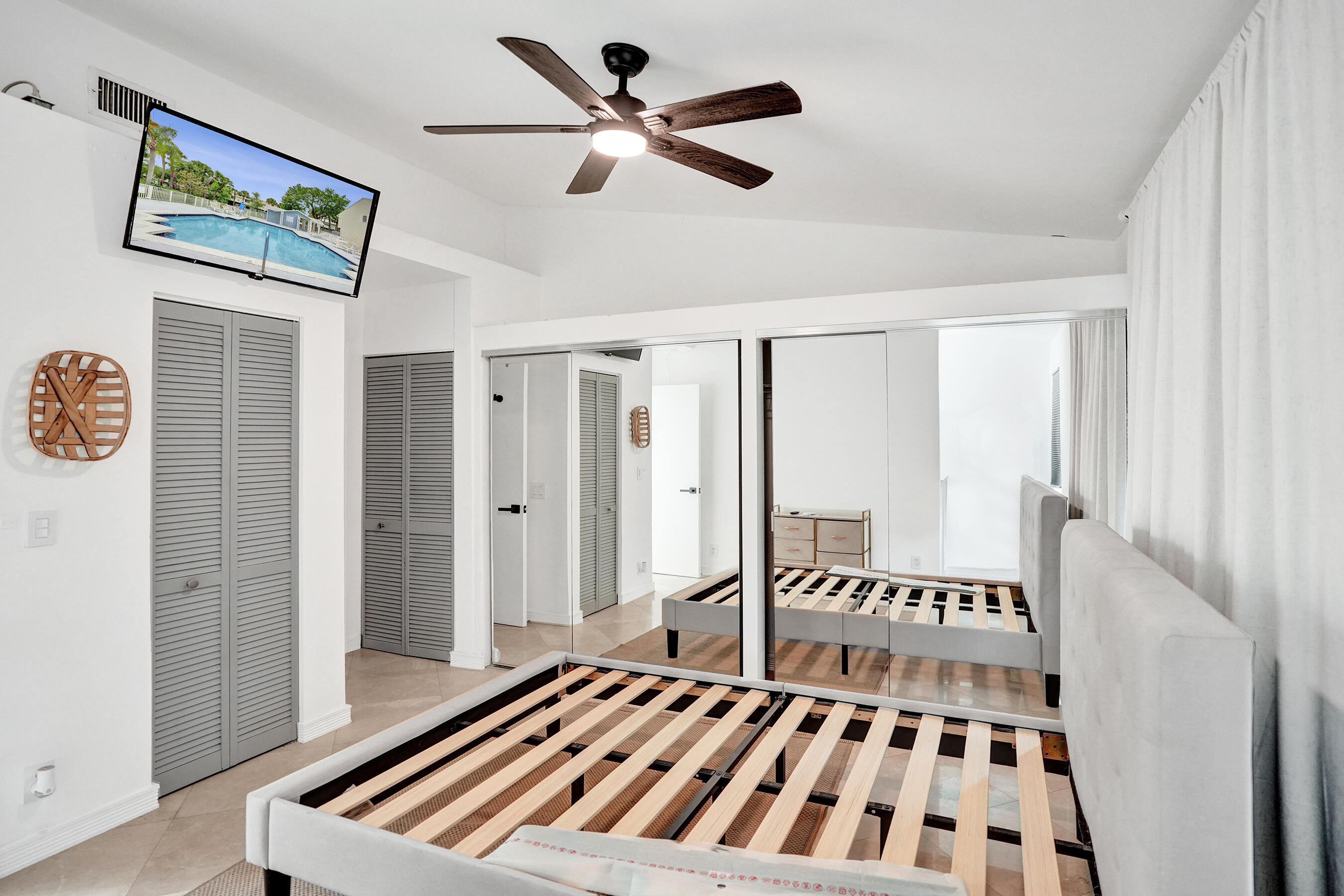 147 Southwest 3rd Street Pompano Beach, FL 33060 - Photo 24 of 29 a bedroom with a bed and a chandelier