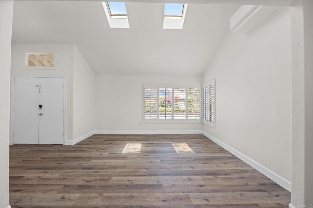 4595 Blackwell Road Oceanside, CA 92056 - Photo 4 of 47 a view of an empty room with wooden floor and a window
