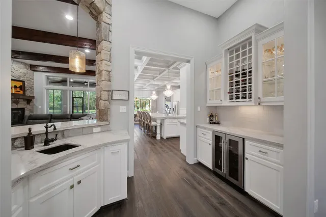 a kitchen with stainless steel appliances a dining table chairs stove and refrigerator
