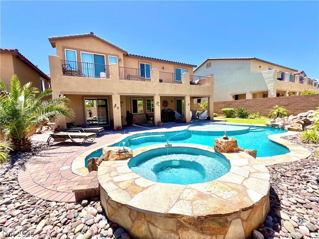 9724 University Ridge Avenue Las Vegas, NV 89149 - Photo 28 of 61 A private backyard oasis features an inviting pool and a raised, stone-clad spa.