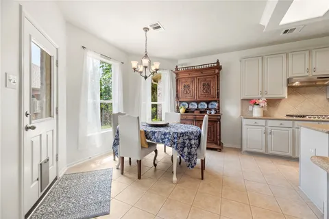a view of a dining room with furniture and chandelier