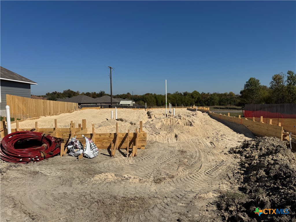 a view of swimming pool with a table and chairs under an umbrella