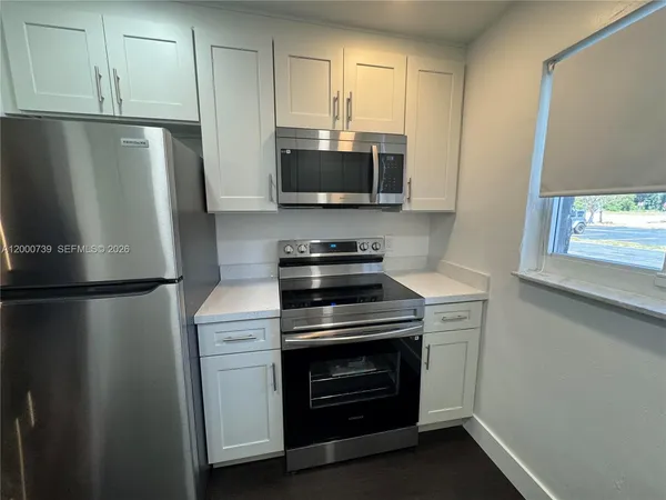 a kitchen with a refrigerator stove and microwave