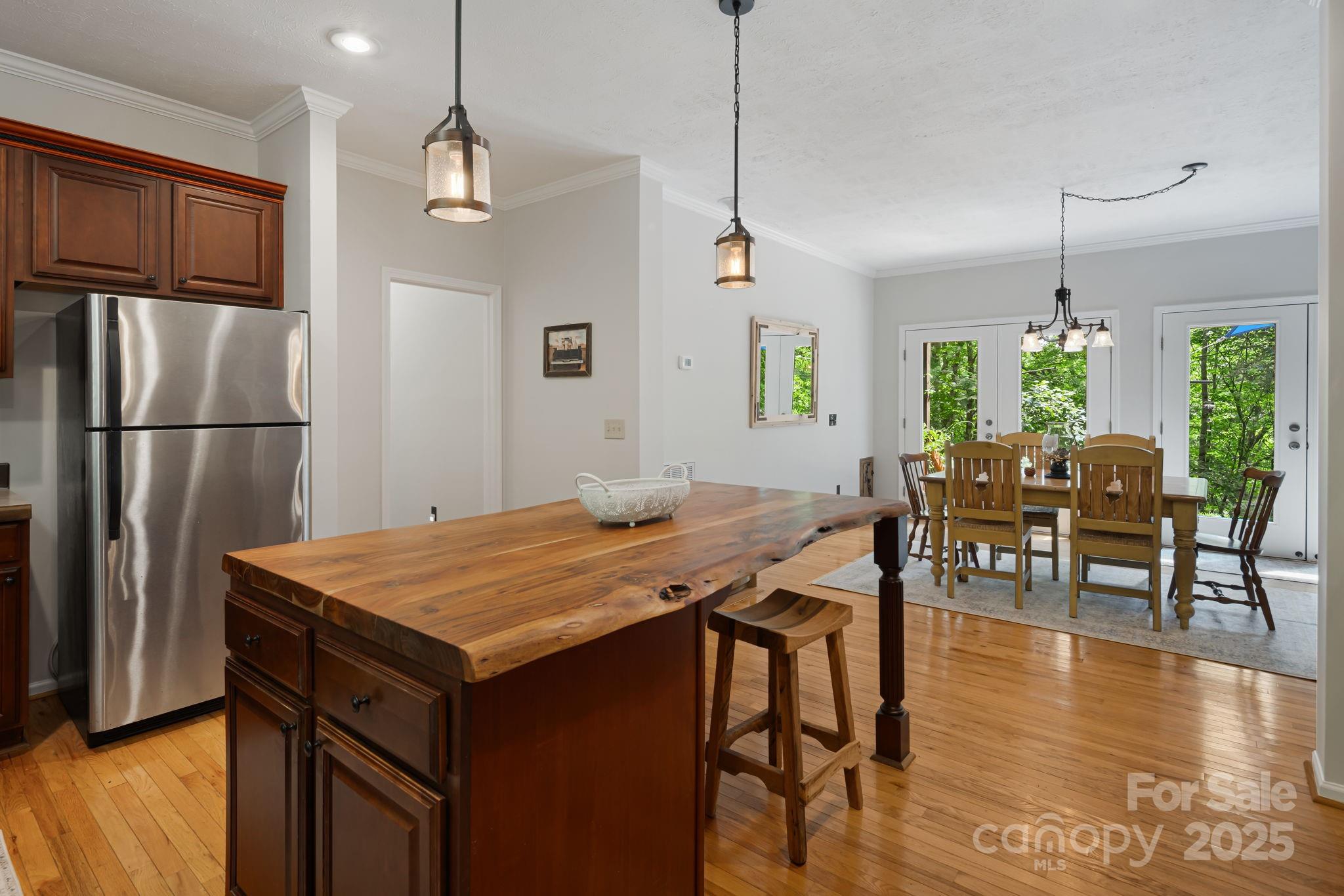 28 Back Stage Pass Leicester, NC 28748 - Photo 20 of 48 a kitchen with stainless steel appliances granite countertop table chairs and refrigerator