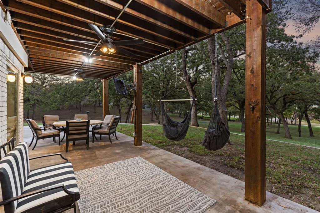 7342 Briar Road Azle, TX 76020 - Photo 29 of 40 Patio terrace at dusk with ceiling fan and a yard