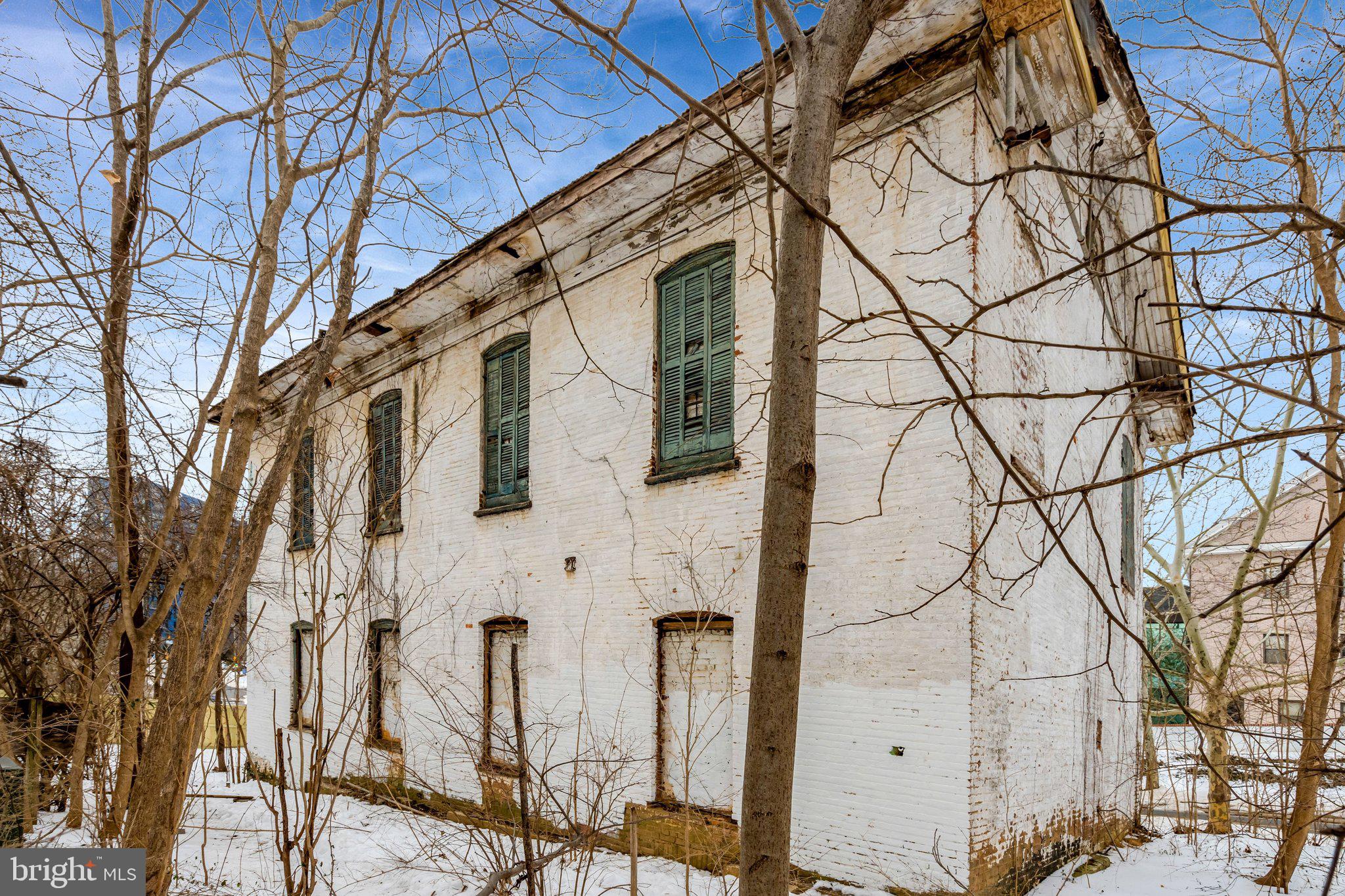 1865 Old Reston Avenue Reston, VA 20190 - Photo 5 of 5 a front view of a building with large trees