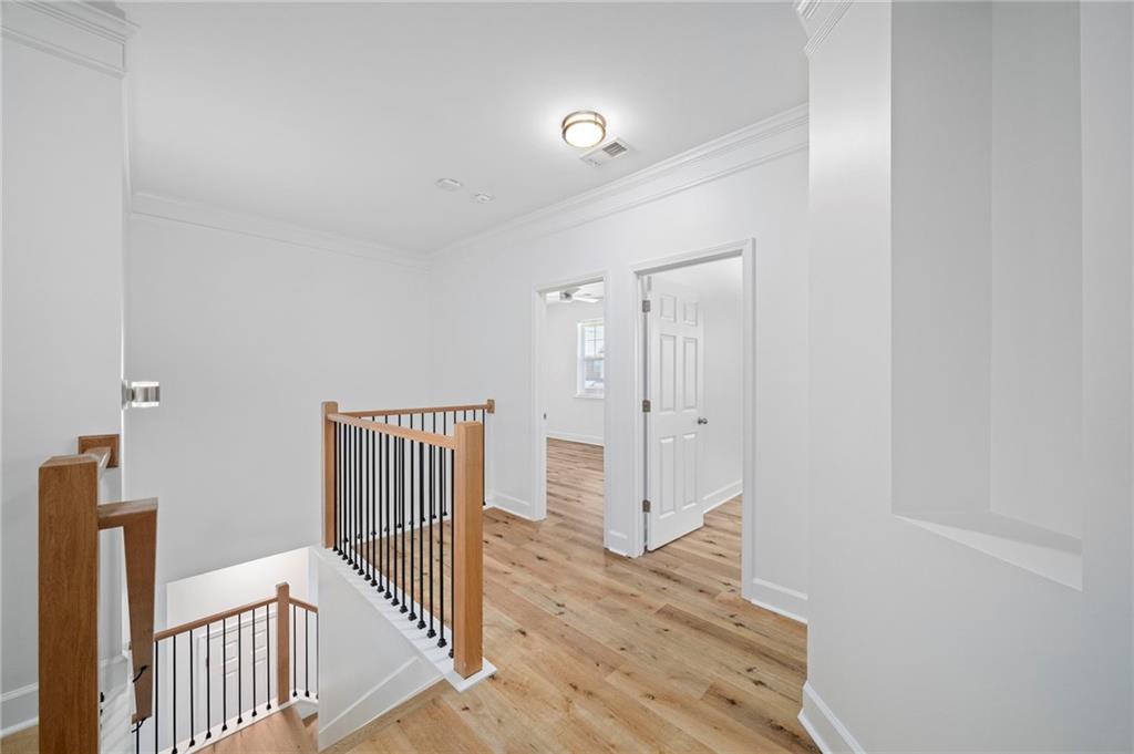 3628 Ashcroft Bend Atlanta, GA 30319 - Photo 22 of 44 a view of a hallway with wooden floor and a bathroom
