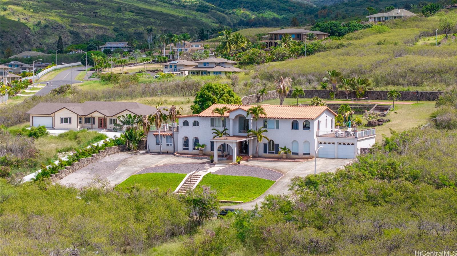 an aerial view of a house with swimming pool and lake view