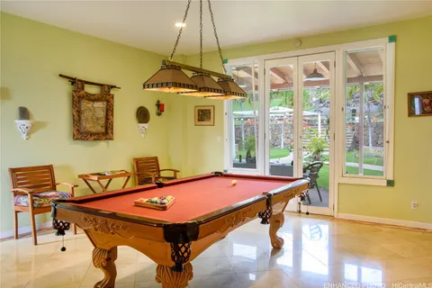 a room with pool table and windows