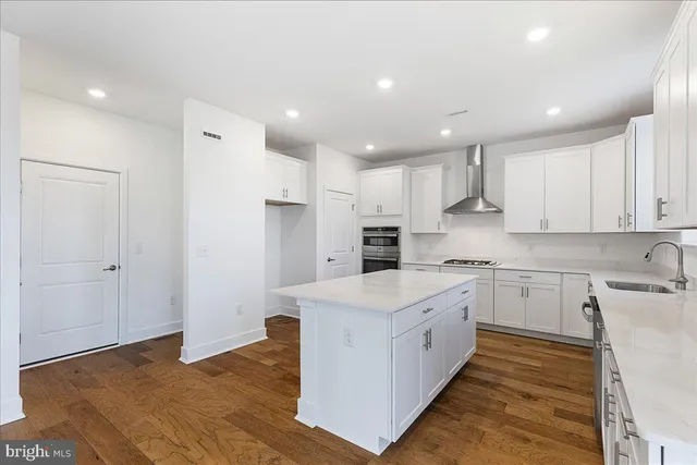 a large kitchen with stainless steel appliances granite countertop a stove a sink and a refrigerator